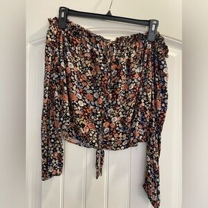 Open shoulder, button up, tie at top and bottom floral peace style shirt. Boho